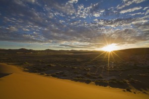 Africa, Namibia, Sun rising over Namib Desert